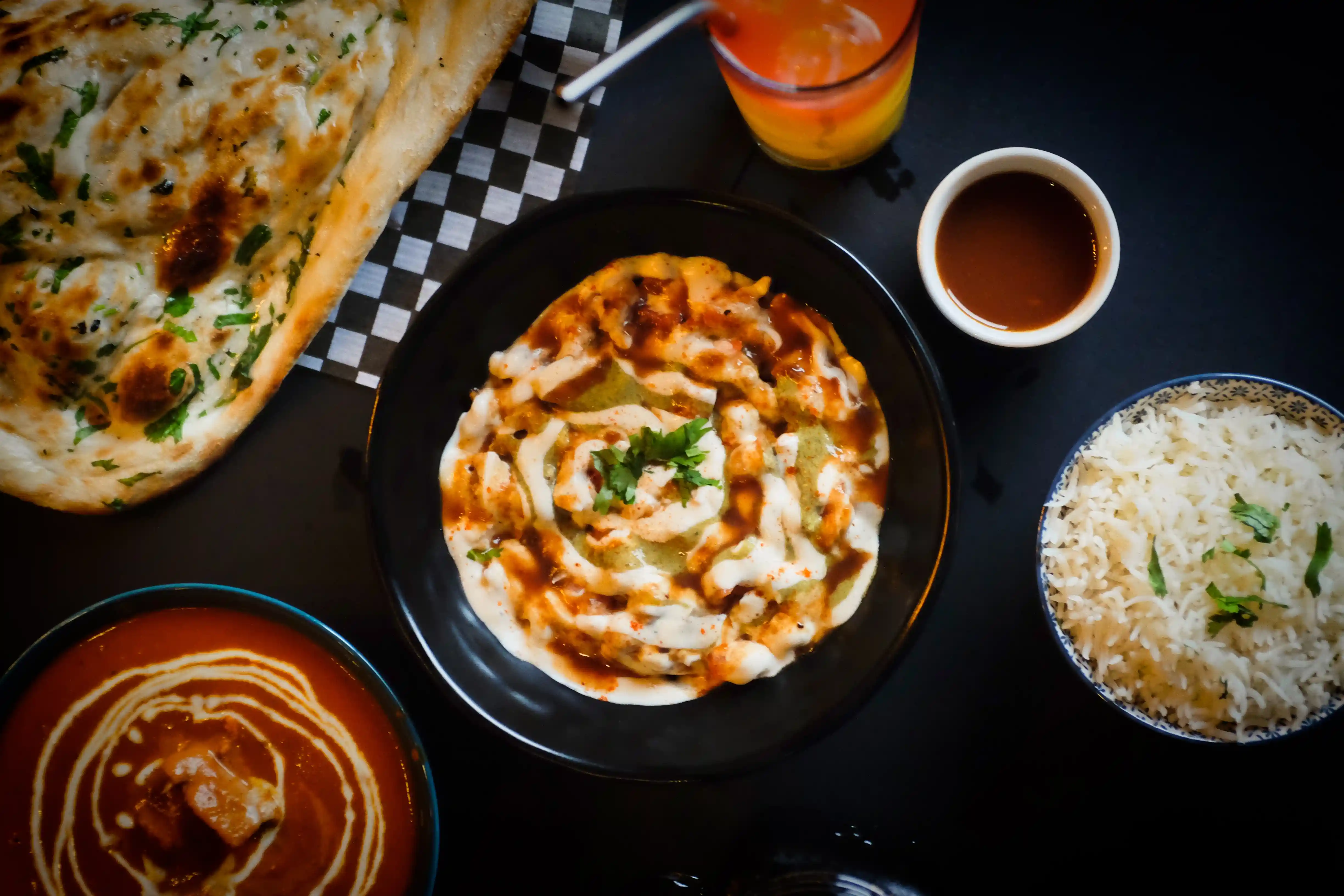 Indian meal spread with butter chicken, garlic naan and basmati rice at Ginger Indian Cuisine, Richmond BC